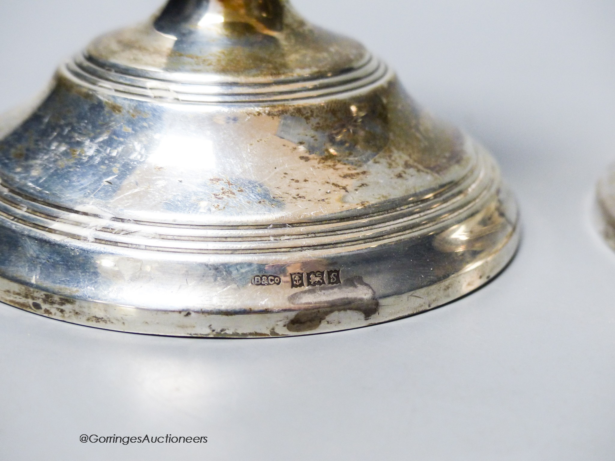 A modern pair of silver mounted dwarf candlesticks, Birmingham, 1967, 12.2cm, weighted.